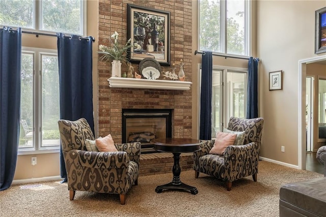 4902 Corinth Dr, Saint Joseph, MO 64506 - sitting room featuring carpet floors, a towering ceiling, and a brick fireplace