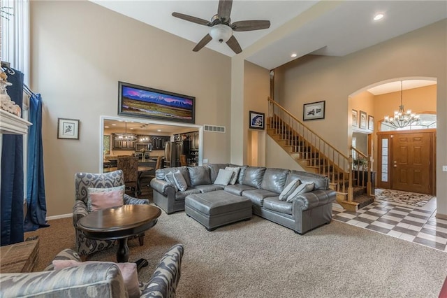4902 Corinth Dr, Saint Joseph, MO 64506 - carpeted living area with a towering ceiling, plenty of natural light, a chandelier, stairs, and ceiling fan