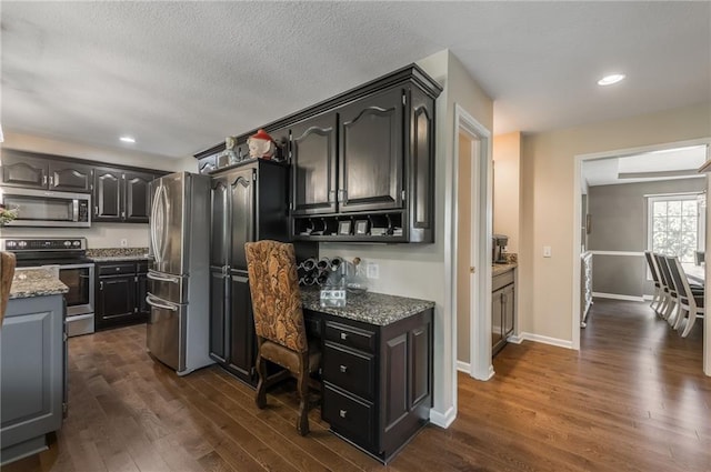 4902 Corinth Dr, Saint Joseph, MO 64506 - kitchen featuring stainless steel appliances, dark wood finished floors, stone countertops, recessed lighting, and an office area