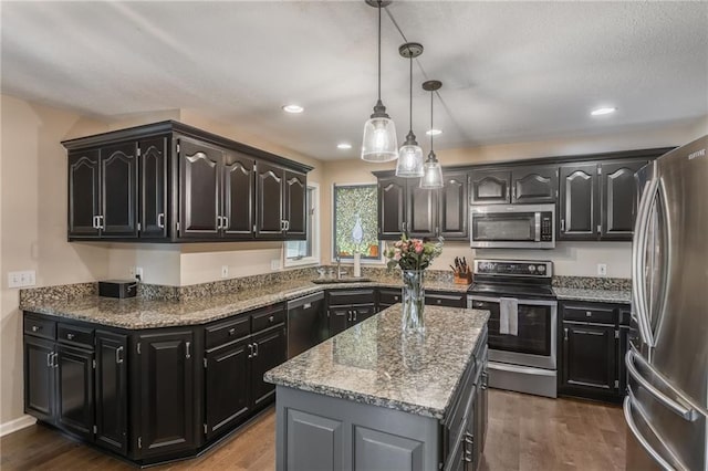 4902 Corinth Dr, Saint Joseph, MO 64506 - kitchen with stainless steel appliances, a kitchen island, dark wood-type flooring, and recessed lighting
