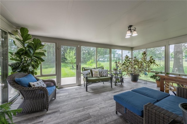 4902 Corinth Dr, Saint Joseph, MO 64506 - sunroom / solarium featuring outdoor lounge area, wood-type flooring, and a chandelier