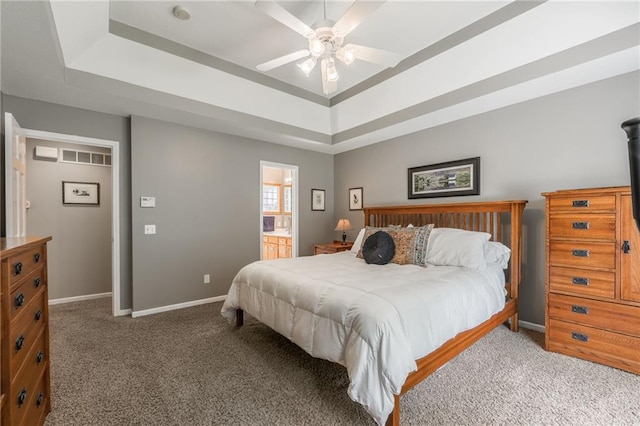 4902 Corinth Dr, Saint Joseph, MO 64506 - carpeted bedroom featuring a raised ceiling, ensuite bath, and ceiling fan