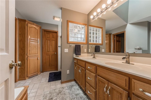 4902 Corinth Dr, Saint Joseph, MO 64506 - bathroom featuring double vanity and tile patterned flooring