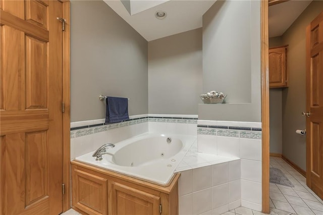 4902 Corinth Dr, Saint Joseph, MO 64506 - bathroom featuring a tub with jets and tile patterned floors