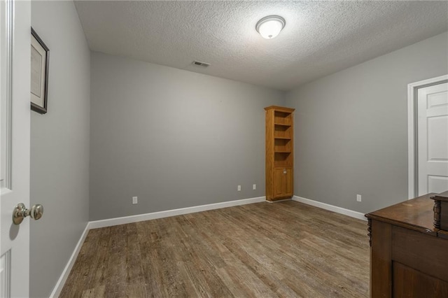 4902 Corinth Dr, Saint Joseph, MO 64506 - spare room with wood finished floors and a textured ceiling