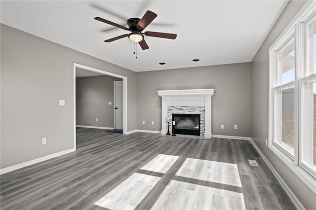 23404 Waverly Rd, Spring Hill, KS 66083 - unfurnished living room featuring dark wood-style flooring, a ceiling fan, and a fireplace with flush hearth