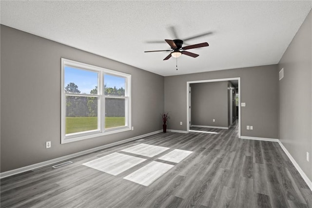 23404 Waverly Rd, Spring Hill, KS 66083 - empty room featuring ceiling fan, wood finished floors, and a textured ceiling