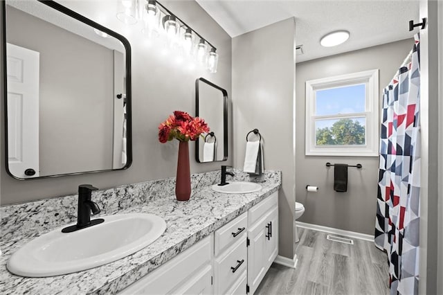 23404 Waverly Rd, Spring Hill, KS 66083 - bathroom with double vanity and wood finished floors