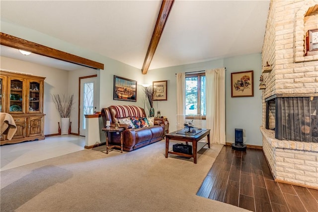 601 W 14th St, Pleasanton, KS 66075 - living room with beamed ceiling, a fireplace, and wood finished floors
