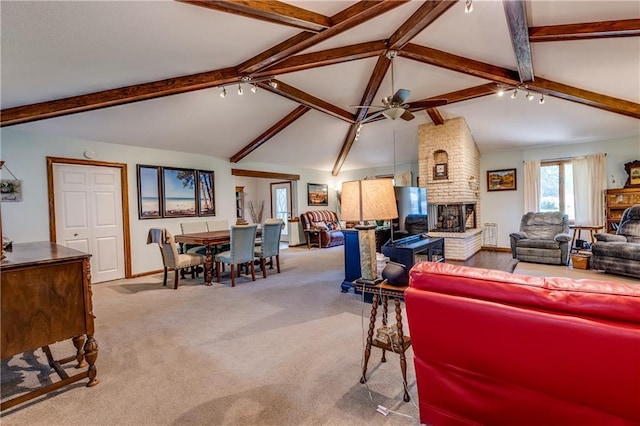 601 W 14th St, Pleasanton, KS 66075 - carpeted living area with a fireplace and a ceiling fan
