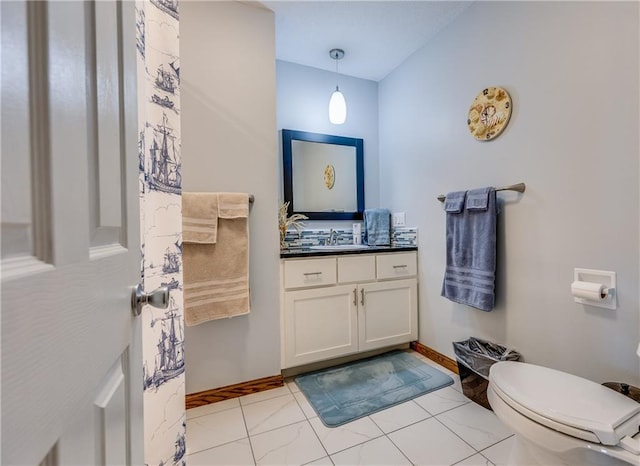 601 W 14th St, Pleasanton, KS 66075 - bathroom featuring vanity and toilet