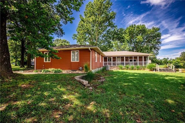 601 W 14th St, Pleasanton, KS 66075 - rear view of house featuring a sunroom and a yard