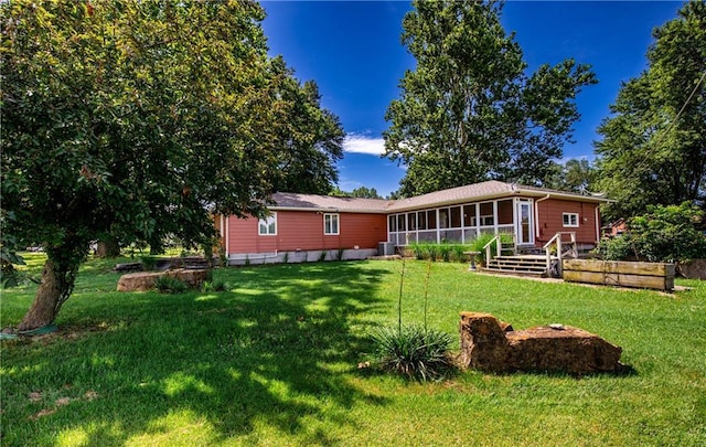 601 W 14th St, Pleasanton, KS 66075 - back of house featuring a sunroom and a lawn