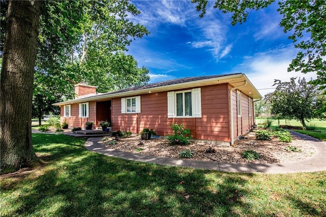 601 W 14th St, Pleasanton, KS 66075 - ranch-style home with a front yard and a chimney