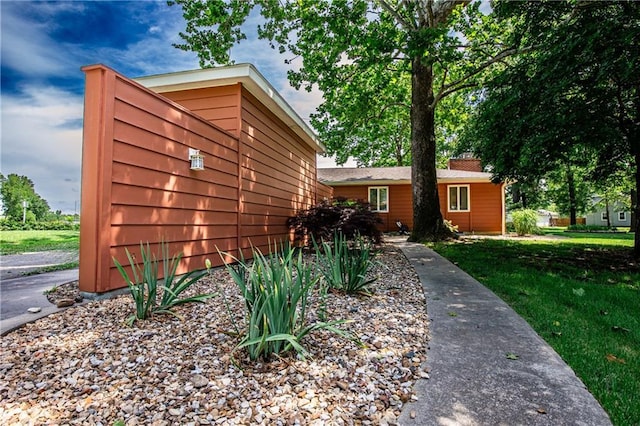 601 W 14th St, Pleasanton, KS 66075 - view of front of home with a front yard and a chimney