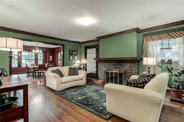 6033 Central St, Kansas City, MO 64113 - living area featuring crown molding, wood finished floors, and a fireplace