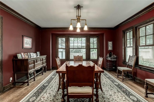 6033 Central St, Kansas City, MO 64113 - dining room featuring crown molding, healthy amount of natural light, and wood finished floors