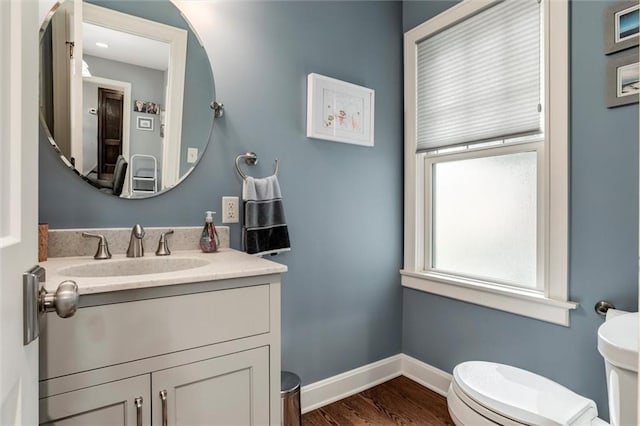 6033 Central St, Kansas City, MO 64113 - half bath featuring vanity and wood finished floors