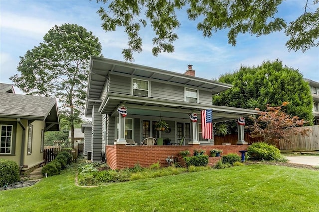 6033 Central St, Kansas City, MO 64113 - view of front of home featuring a chimney and a porch