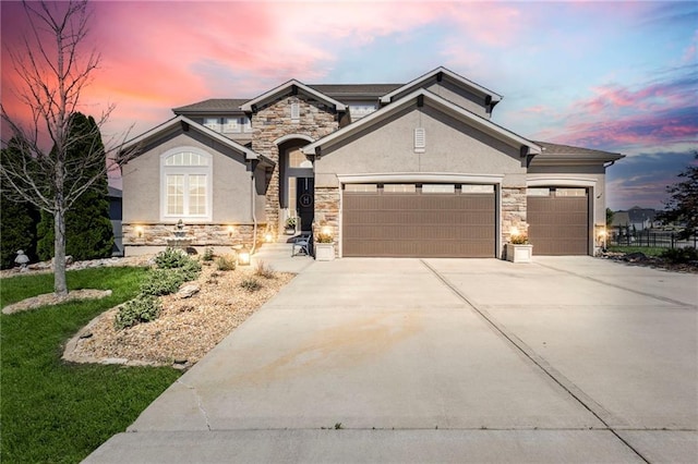 1401 Spurlock Cv, Raymore, MO 64083 - french country inspired facade with stone siding, an attached garage, concrete driveway, and stucco siding