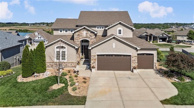 1401 Spurlock Cv, Raymore, MO 64083 - view of front of home with stone siding, stucco siding, driveway, an attached garage, and a residential view