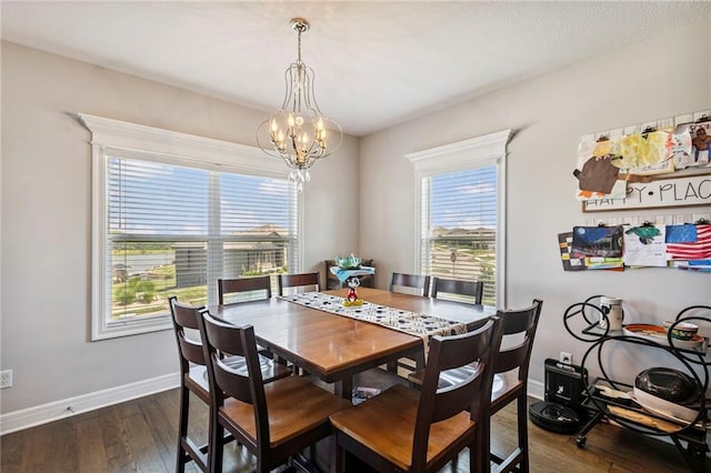 1401 Spurlock Cv, Raymore, MO 64083 - dining room with a chandelier and dark wood-style flooring