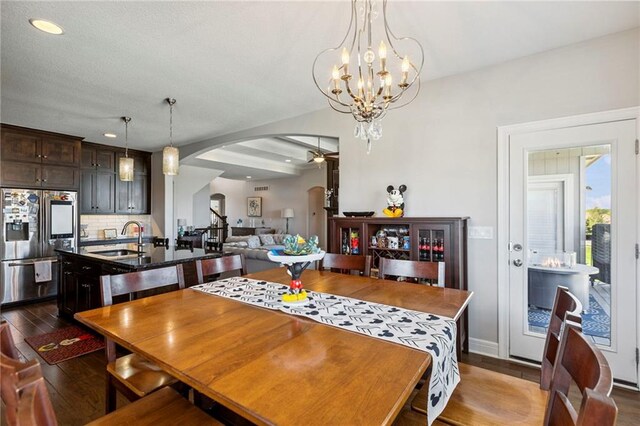 1401 Spurlock Cv, Raymore, MO 64083 - dining room featuring arched walkways, dark wood-type flooring, recessed lighting, and a chandelier