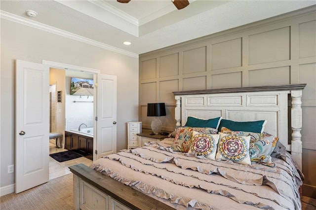 1401 Spurlock Cv, Raymore, MO 64083 - bedroom with ornamental molding, a decorative wall, recessed lighting, a raised ceiling, and ensuite bathroom