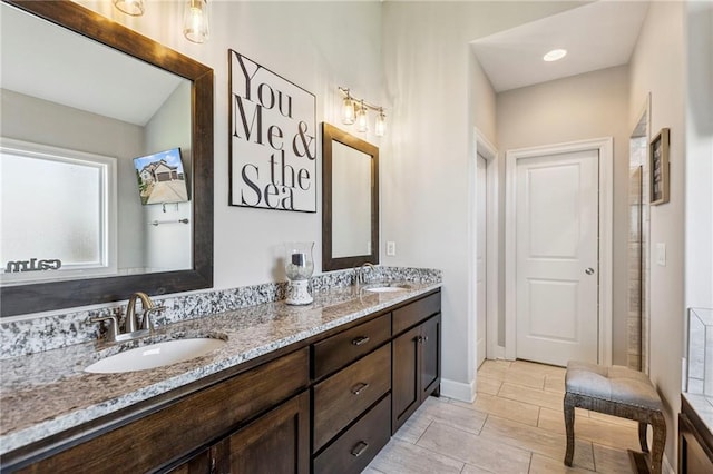1401 Spurlock Cv, Raymore, MO 64083 - bathroom with double vanity and baseboards