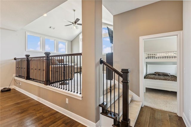 1401 Spurlock Cv, Raymore, MO 64083 - staircase featuring ceiling fan, wood finished floors, and vaulted ceiling
