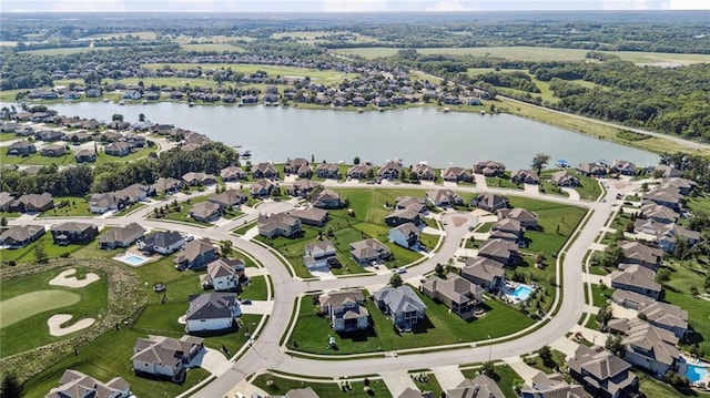 1401 Spurlock Cv, Raymore, MO 64083 - aerial overview of property's location with a nearby body of water and nearby suburban area