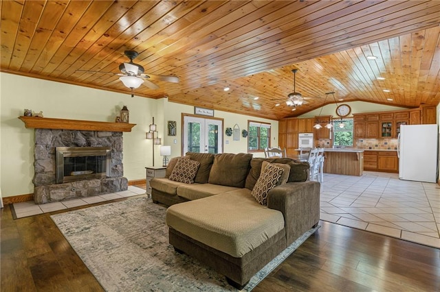20212 S Carriage Ln, Peculiar, MO 64078 - living area with ceiling fan, lofted ceiling, wooden ceiling, light wood finished floors, and a stone fireplace