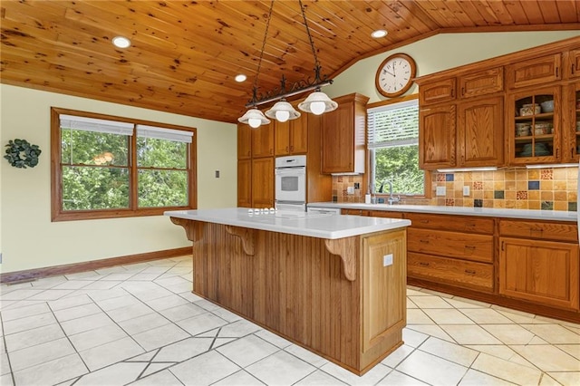 20212 S Carriage Ln, Peculiar, MO 64078 - kitchen featuring wooden ceiling, lofted ceiling, white oven, light countertops, and brown cabinetry