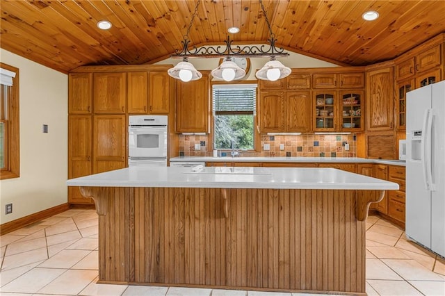 20212 S Carriage Ln, Peculiar, MO 64078 - kitchen with white appliances, lofted ceiling, light tile patterned floors, a center island, and light countertops