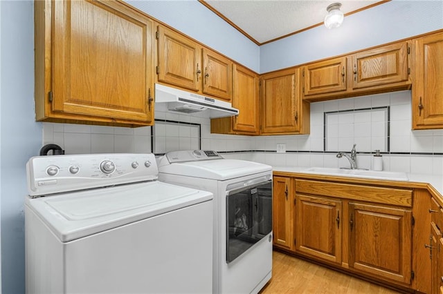 20212 S Carriage Ln, Peculiar, MO 64078 - washroom with washer and dryer, cabinet space, and light wood-style floors