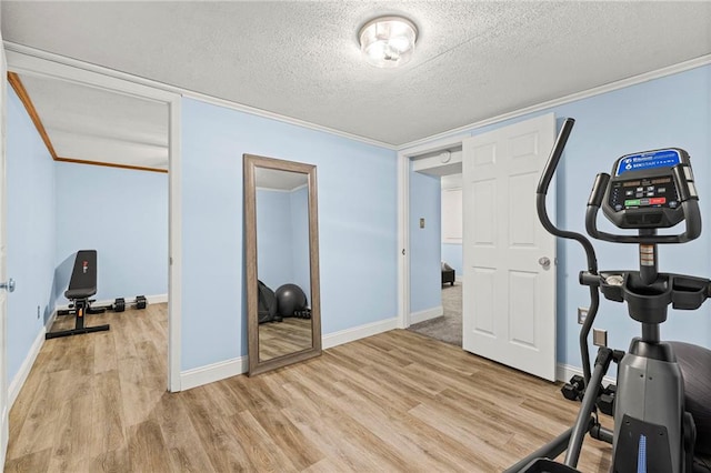20212 S Carriage Ln, Peculiar, MO 64078 - exercise area featuring light wood finished floors, a textured ceiling, and ornamental molding