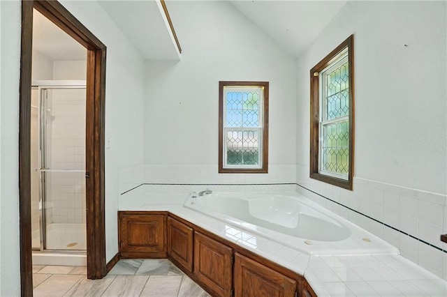 802 S Morgan Dr, Peculiar, MO 64078 - full bathroom featuring a bath, a shower stall, lofted ceiling, and tile patterned flooring