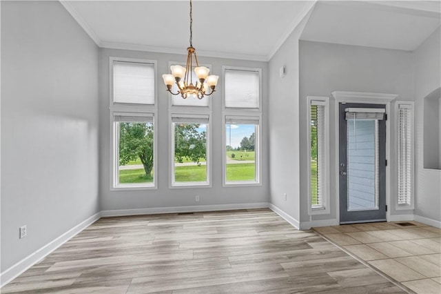 13785 E Nelson Rd, Nevada, MO 64772 - entrance foyer with healthy amount of natural light, a chandelier, crown molding, and wood finished floors