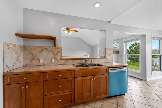 13785 E Nelson Rd, Nevada, MO 64772 - kitchen with dishwasher, brown cabinets, vaulted ceiling, and light countertops