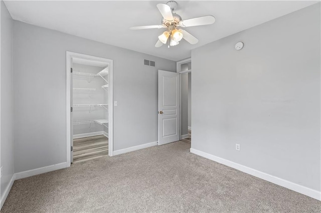 13785 E Nelson Rd, Nevada, MO 64772 - unfurnished bedroom with carpet, a closet, a ceiling fan, and a spacious closet