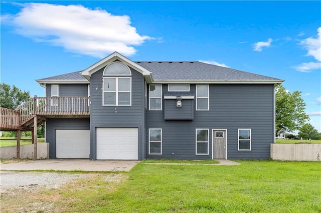 13785 E Nelson Rd, Nevada, MO 64772 - view of front of house with driveway, an attached garage, a wooden deck, and a shingled roof