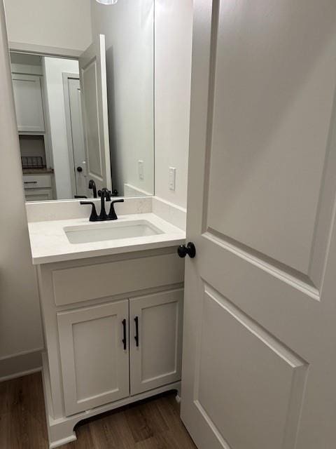1309 N 4th St E, Louisburg, KS 66053 - bathroom featuring wood finished floors and vanity