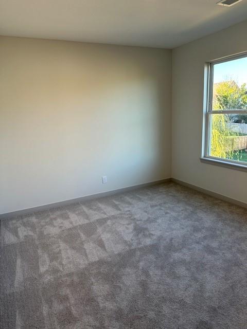 1309 N 4th St E, Louisburg, KS 66053 - carpeted empty room with baseboards
