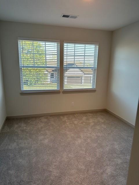 1309 N 4th St E, Louisburg, KS 66053 - spare room with carpet flooring and baseboards