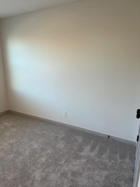 1309 N 4th St E, Louisburg, KS 66053 - carpeted empty room with baseboards