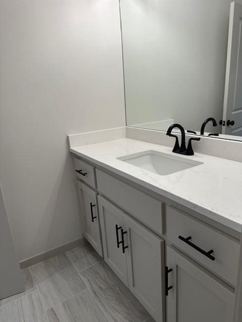 1309 N 4th St E, Louisburg, KS 66053 - bathroom featuring vanity and baseboards