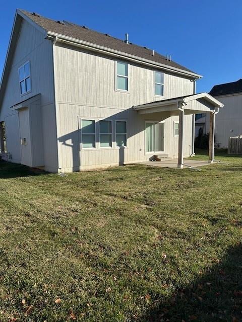 1309 N 4th St E, Louisburg, KS 66053 - back of property with a patio area and a lawn