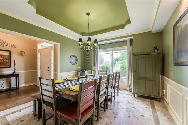 2621 SE 5th St, Lees Summit, MO 64063 - dining space with a tray ceiling, a chandelier, a wainscoted wall, a decorative wall, and crown molding