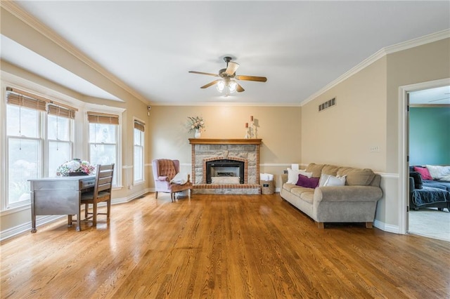 2621 SE 5th St, Lees Summit, MO 64063 - living room with a ceiling fan, light wood-type flooring, ornamental molding, and a brick fireplace