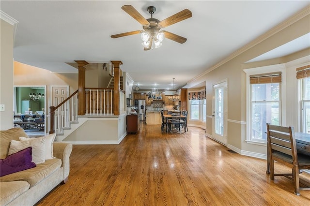 2621 SE 5th St, Lees Summit, MO 64063 - living room with light wood-type flooring, stairs, ceiling fan, and crown molding